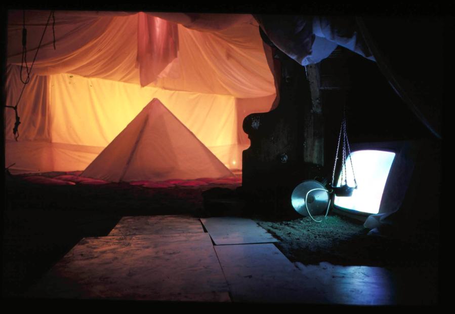 Picture taken from the
Hundstage exhibition, showing a moody lit pyramid and a
television display buried in dark shadows